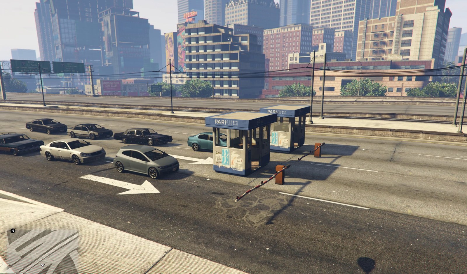 A three-lane toll plaza across an elevated freeway through downtown Los Santos: a kiosk on each island, barrier arms down across two lanes, and cars waiting in line behind them